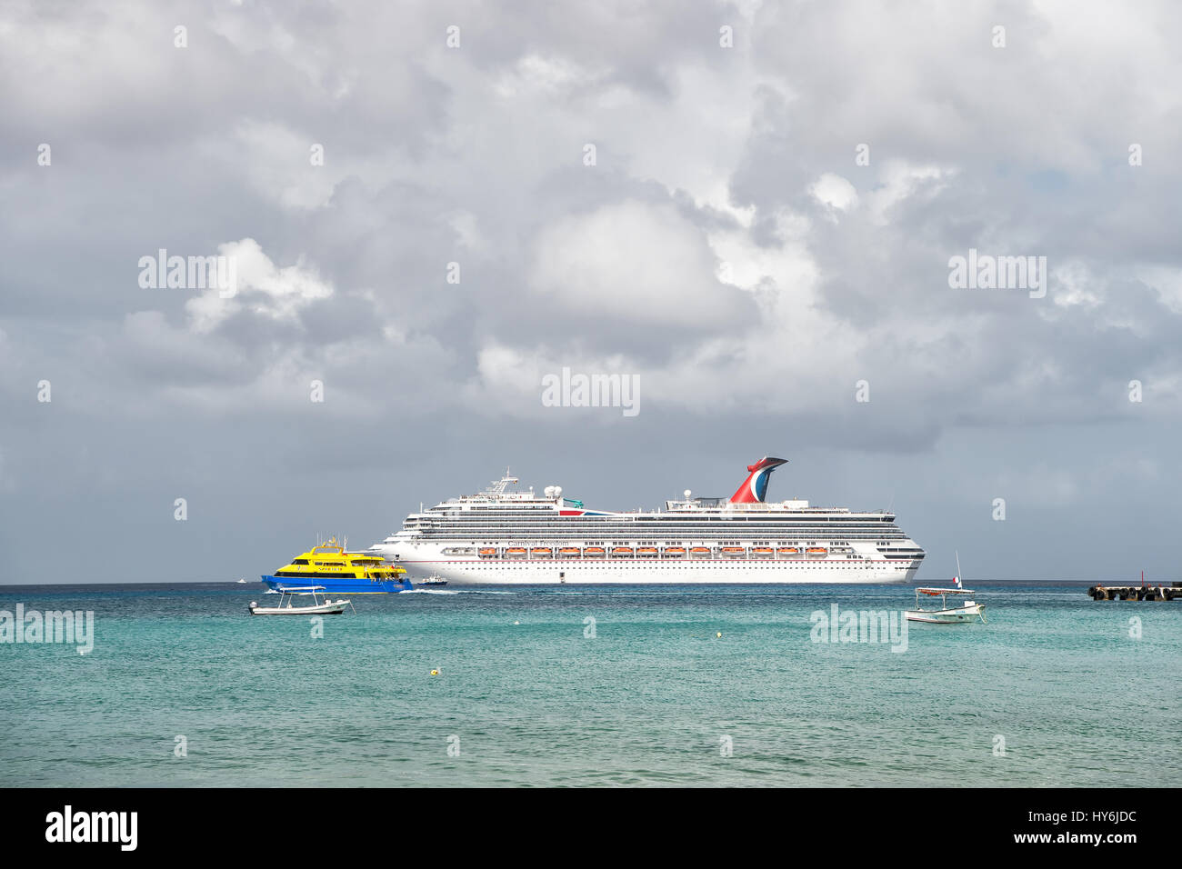 Cozumel, Mexico - December 24, 2015: large cruise ship or liner in bay or harbor, touristic passenger boat on water summer day on cloudy sky backgroun Stock Photo