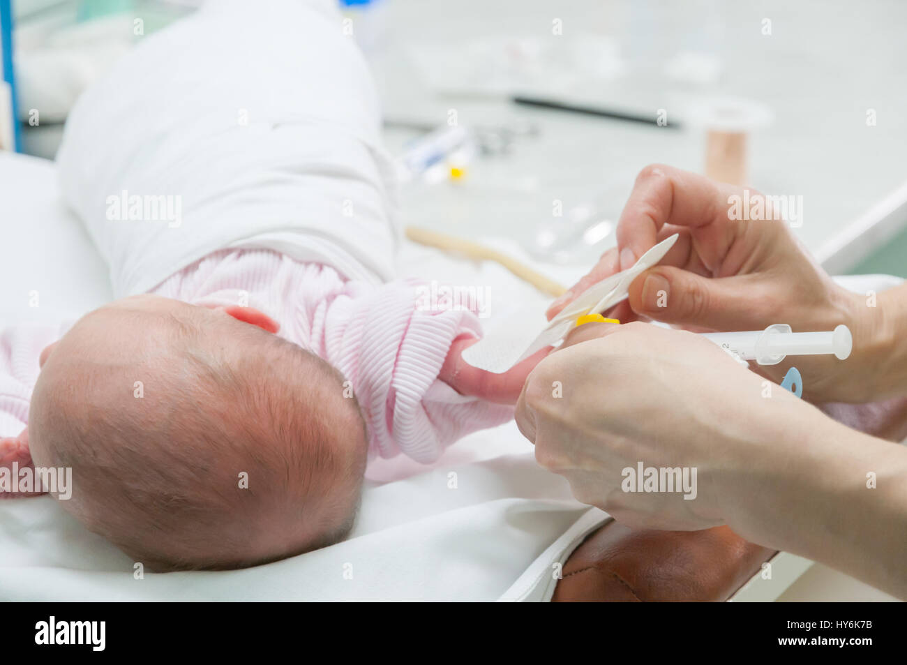 Doctor making drainage for newborn baby. Stock Photo