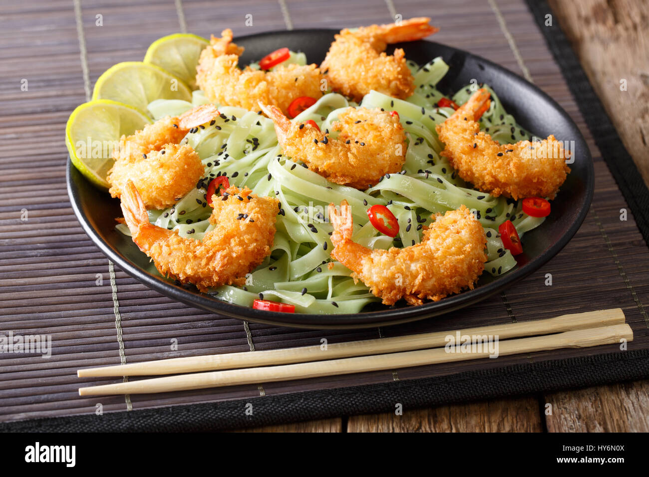 Shrimp tempura with green tea Macha pasta and sesame close-up on a plate. horizontal Stock Photo