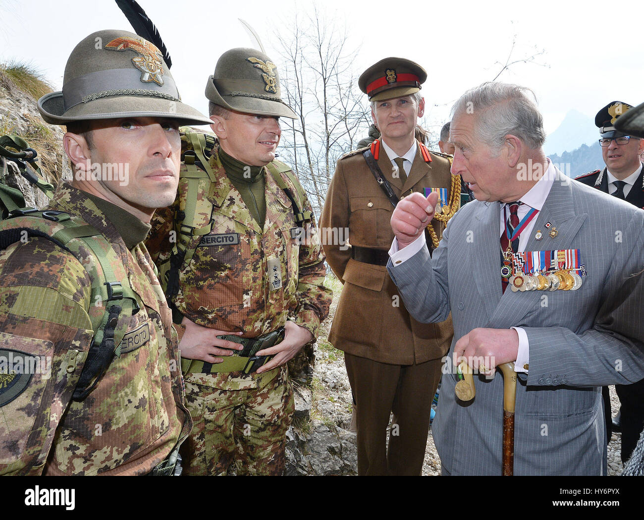The Prince of Wales with soldiers from Italy's Alpini mountain warfare military corps in the Dolomite mountains in northern Italy, where British soldiers fought alongside Italians against the Austrians in the First World War. Stock Photo
