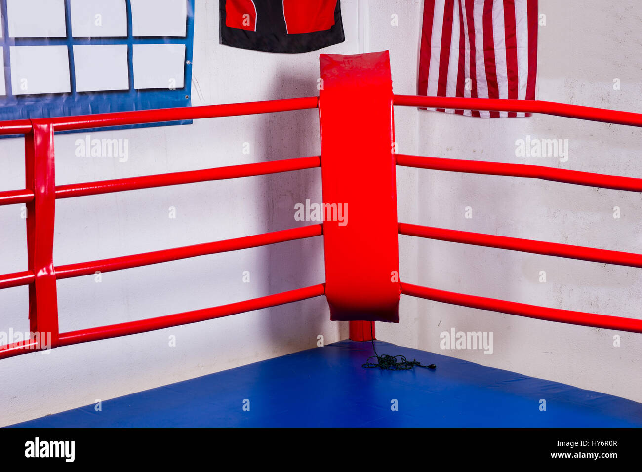 Red corner of a regular boxing ring surrounded by ropes in a gym Stock Photo Alamy