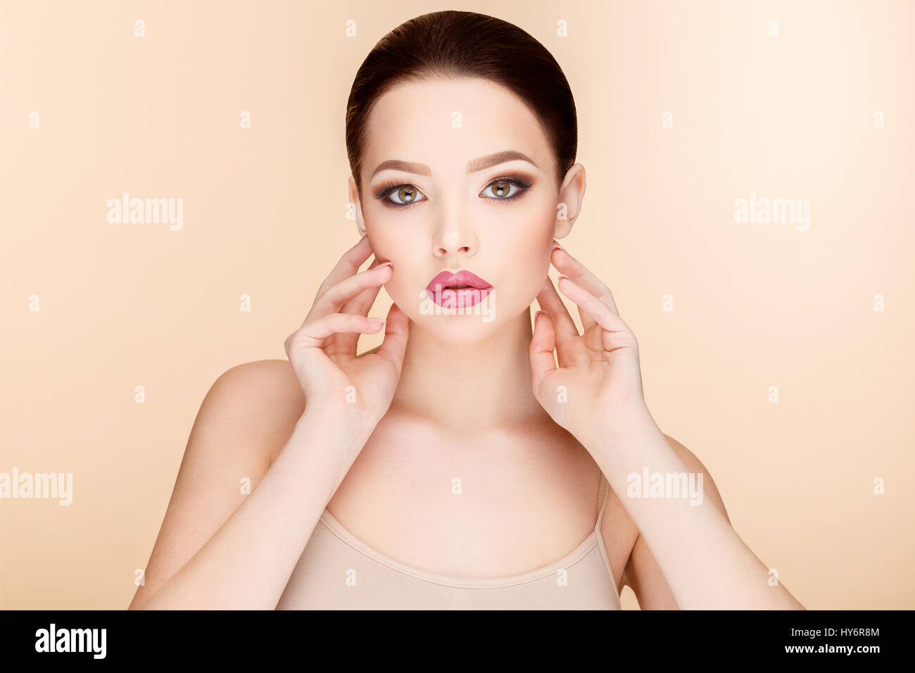 Beautiful Face of Young Woman with Clean Fresh Skin close up on beige ...