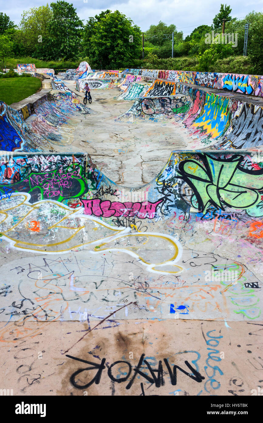 Boy on a BMX bike in the concrete Victorian sewer beds in Markfield Park, Tottenham, London, UK, now a bike and skateboard play area Stock Photo