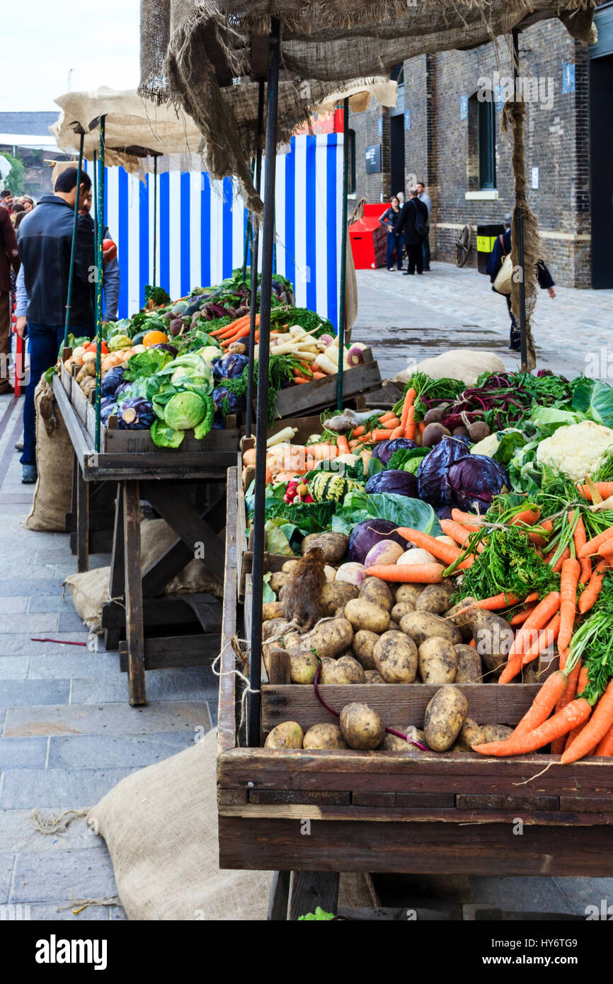 Period barrows containing vegetables at a Victorian-themed fair and market in Granary Square, King's Cross, London, UK Stock Photo