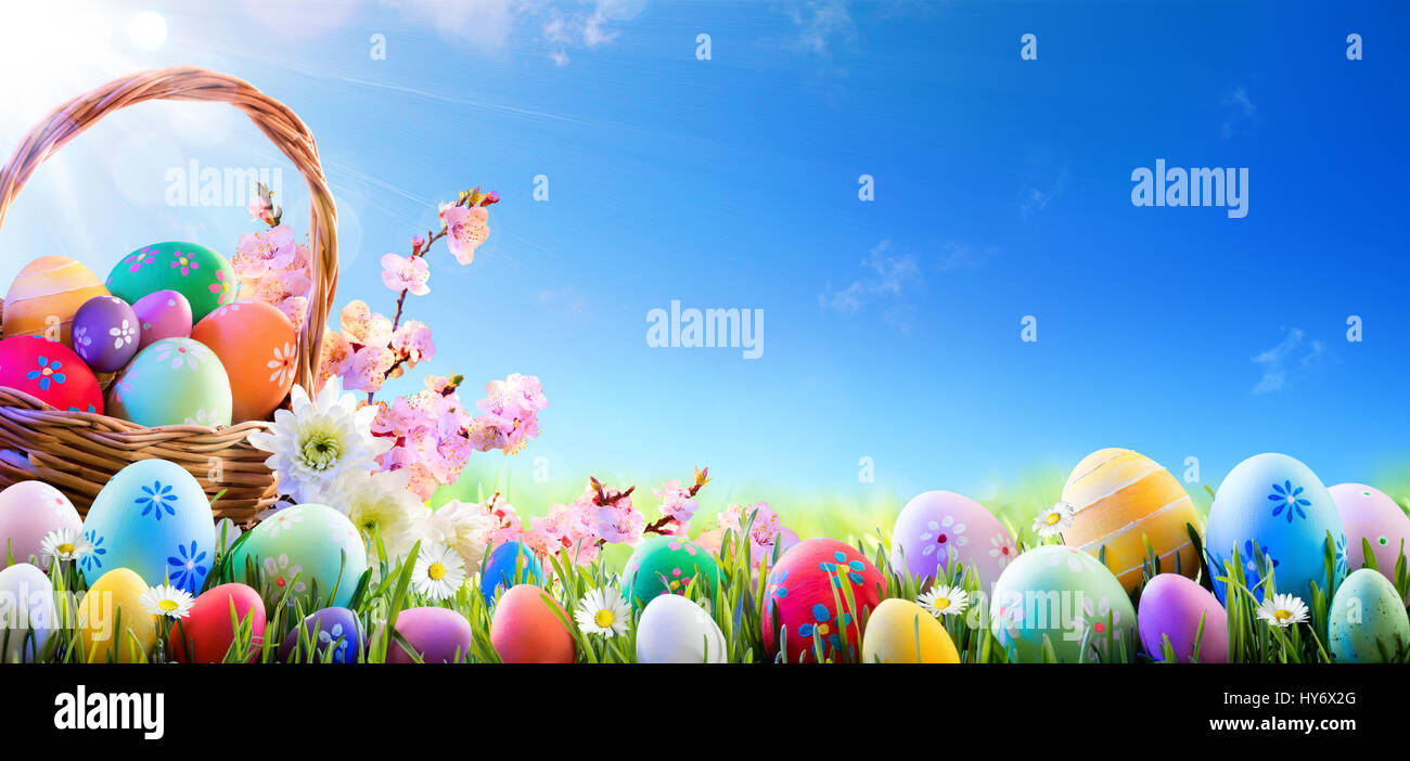Easter Eggs In Basket And On Meadow Stock Photo - Alamy