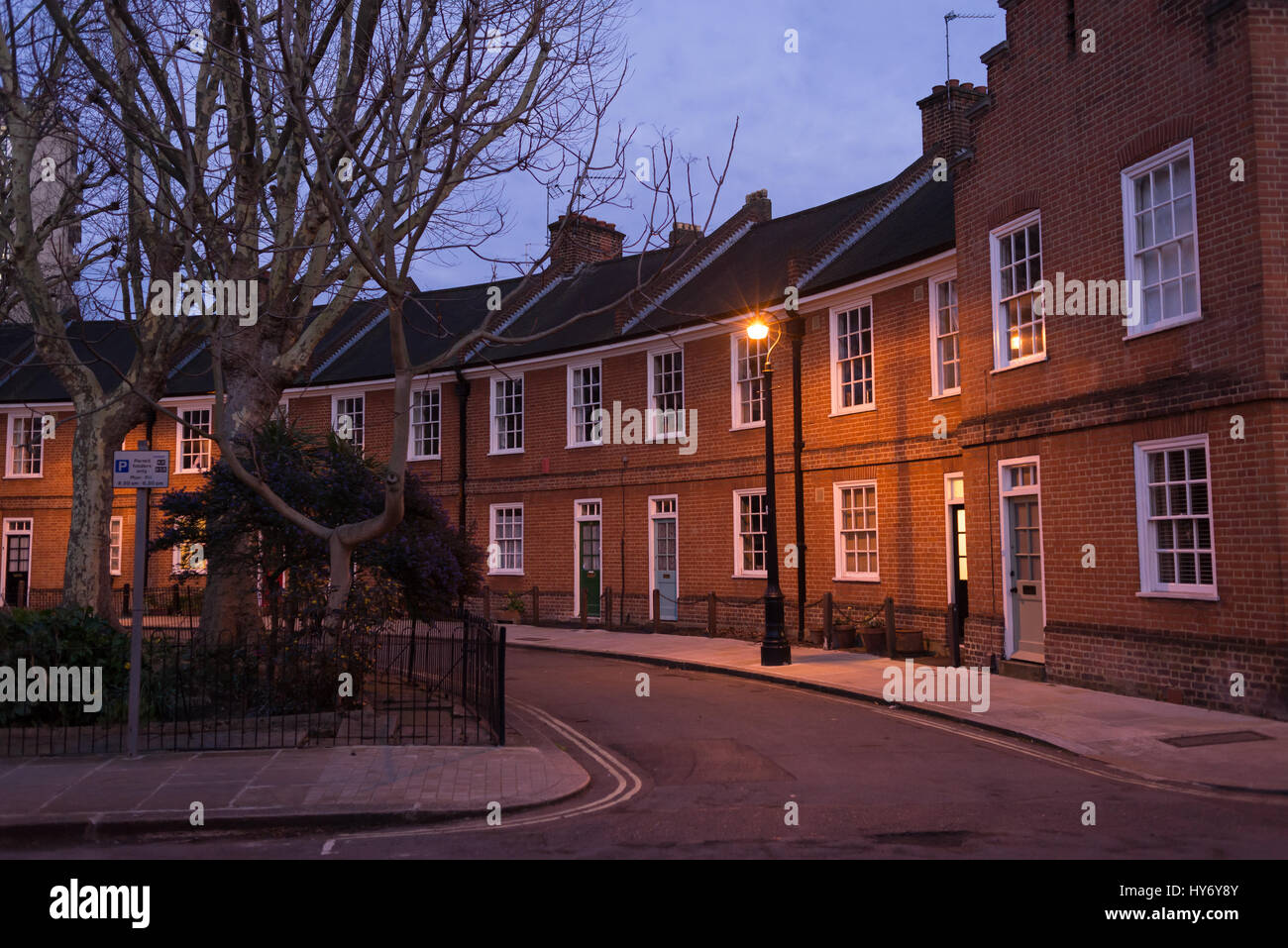 Restored Edwardian brick houses on a local road at night with street lamp Stock Photo