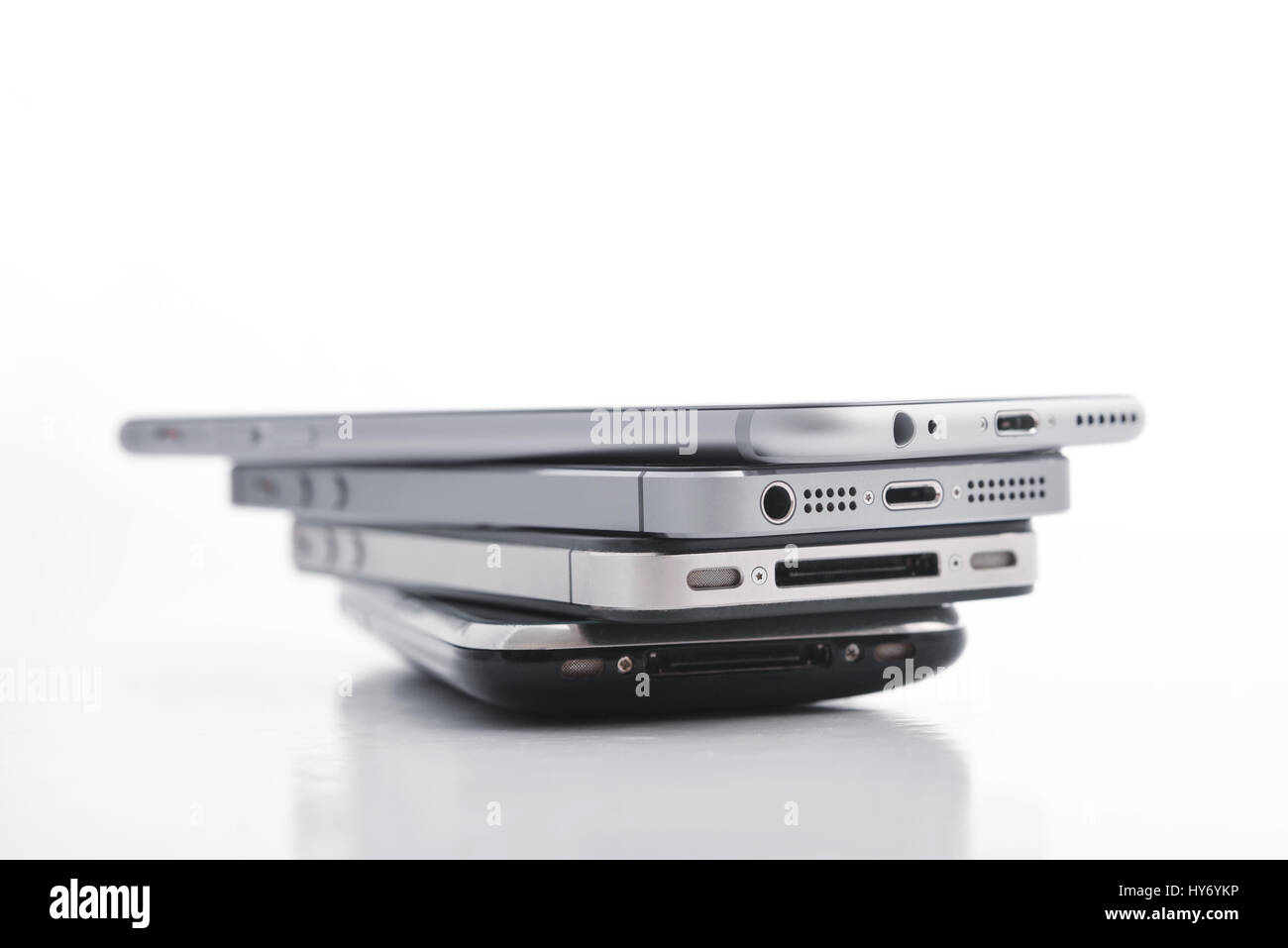 Kiev, Ukraine - March 05, 2016: Pile of Apple iPhone 5s, Apple iPhone 6, Apple iPhone 4 and Apple iPhone 3gs. Apple Inc. is an American multinational  Stock Photo