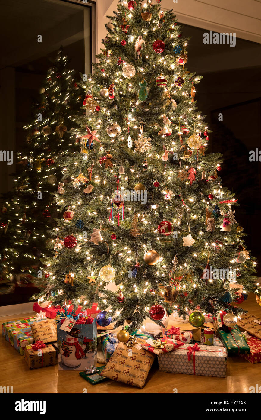 Christmas tree with gifts inside home Stock Photo Alamy
