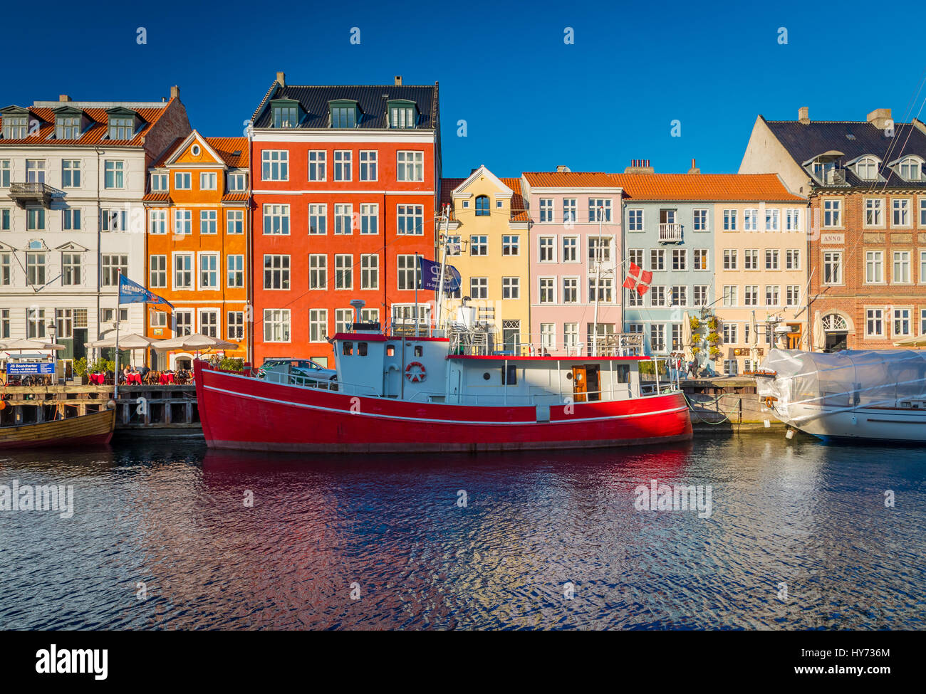Nyhavn is a colourful 17th century waterfront, canal and popular entertainment district in Copenhagen, Denmark. Stock Photo