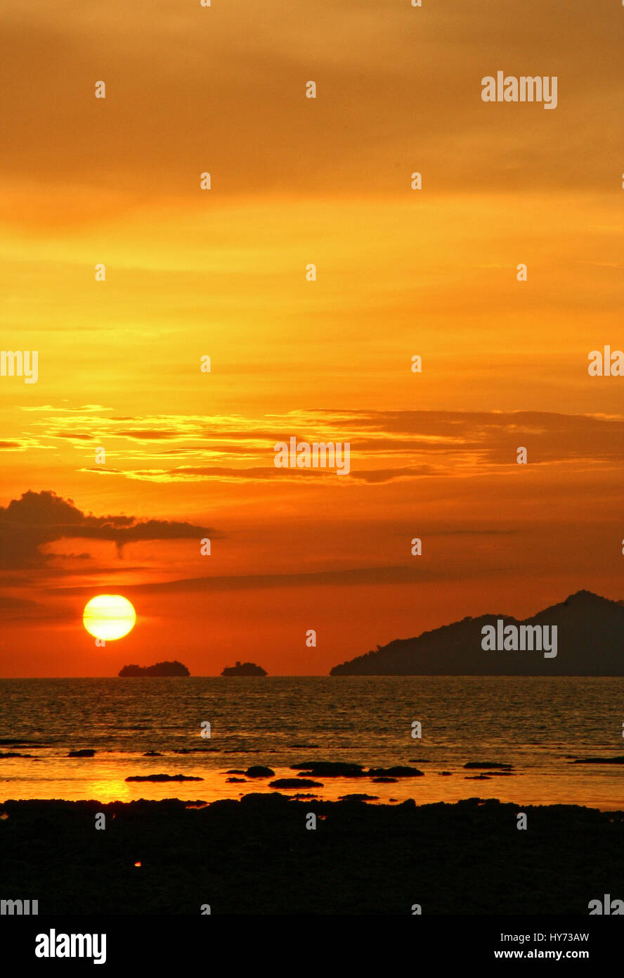 Beautiful tropical sunset beach , silhouette over the sea Stock Photo ...