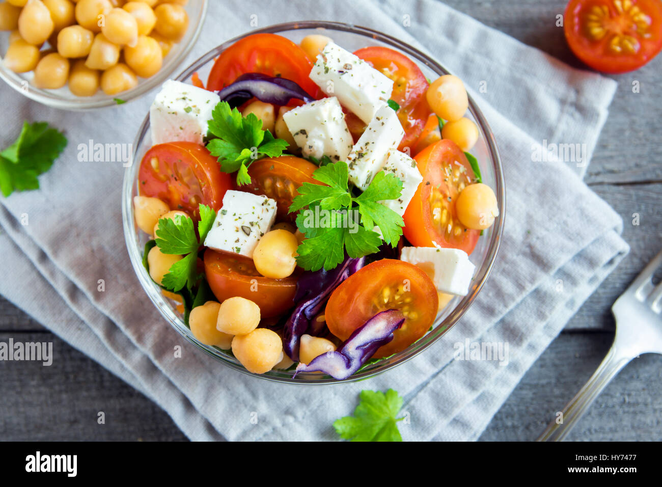 Chickpea and veggie salad with tomatoes, red cabbage, feta cheese (tofu) - healthy homemade vegan vegetarian diet detox salad meal food. Stock Photo