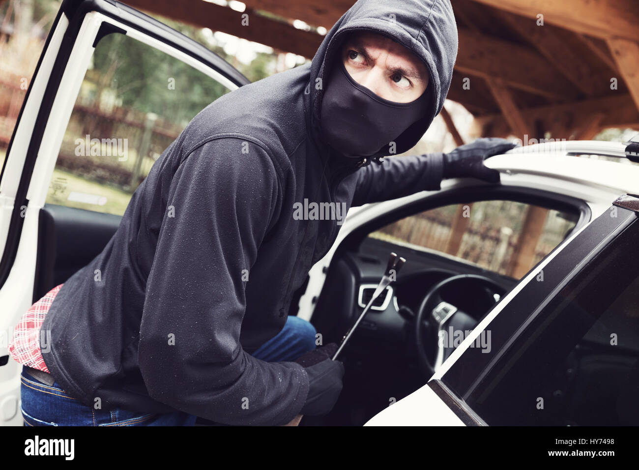 thief steals car Stock Photo