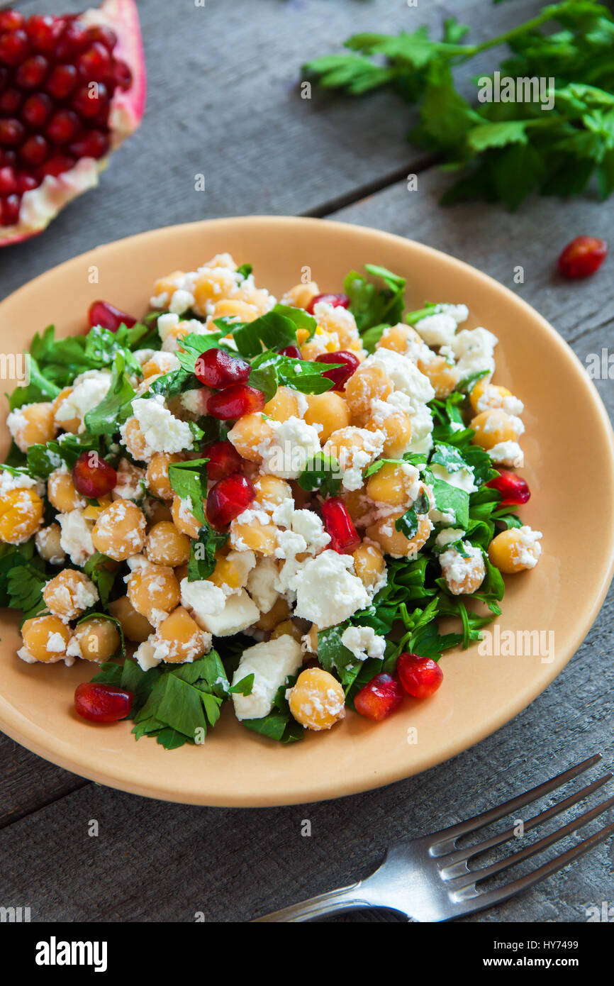 Chickpea salad with fresh feta cheese, parsley and pomegranate seeds