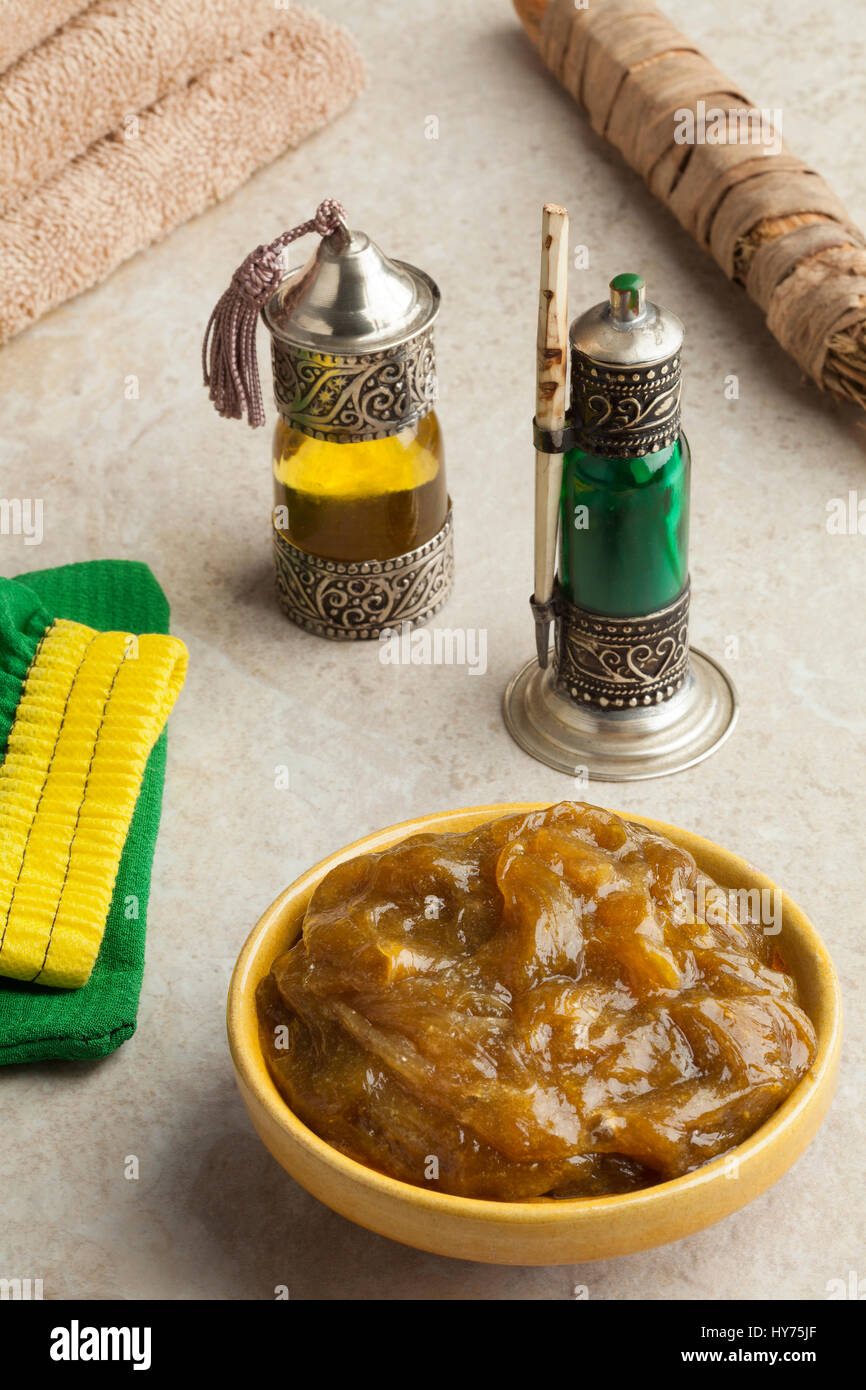 Traditional bowl with Moroccan black argan soap,toothbrush, bottle with kohl and oil in hammam Stock Photo