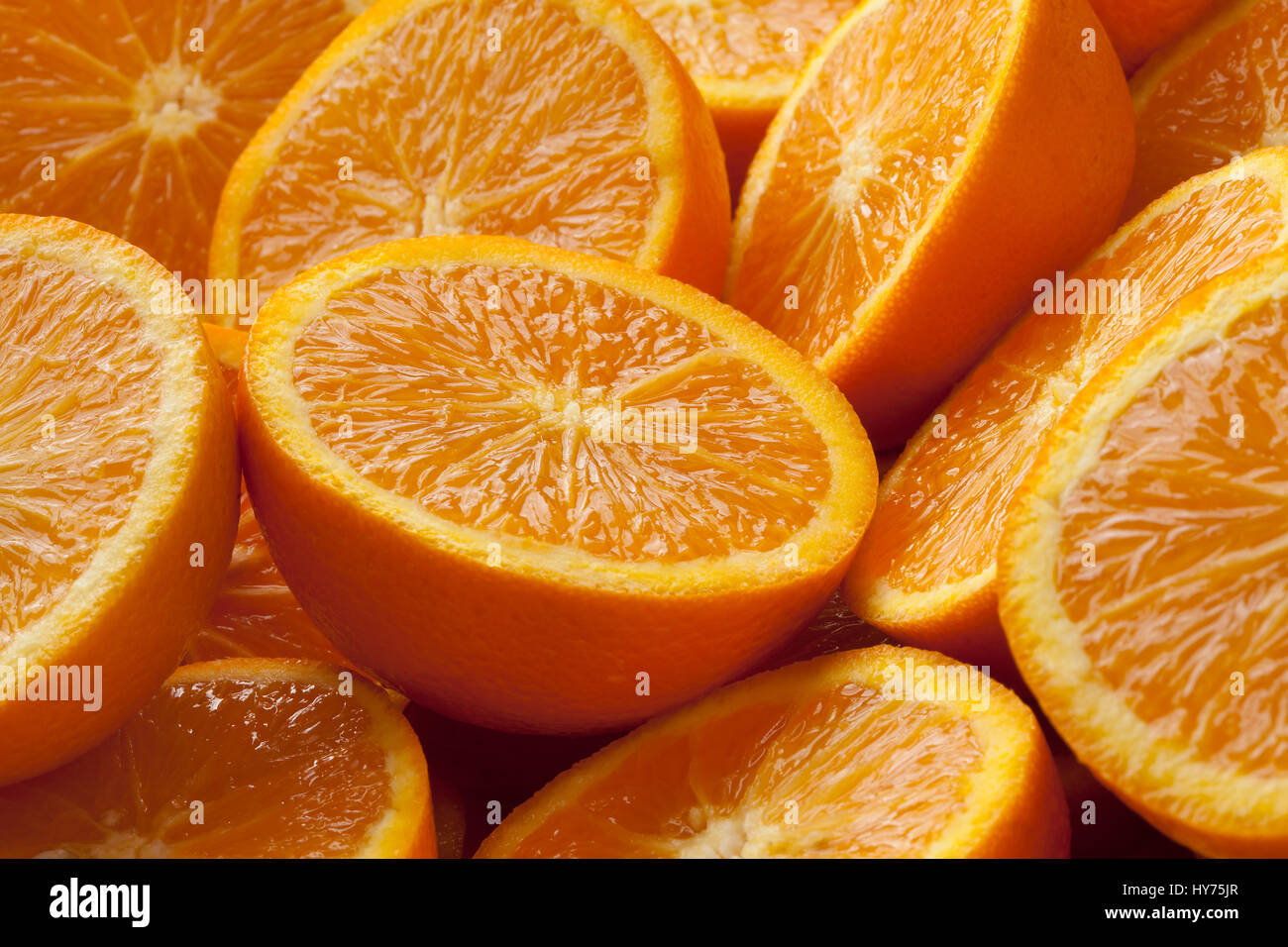 Fresh cut half oranges full frame close up Stock Photo