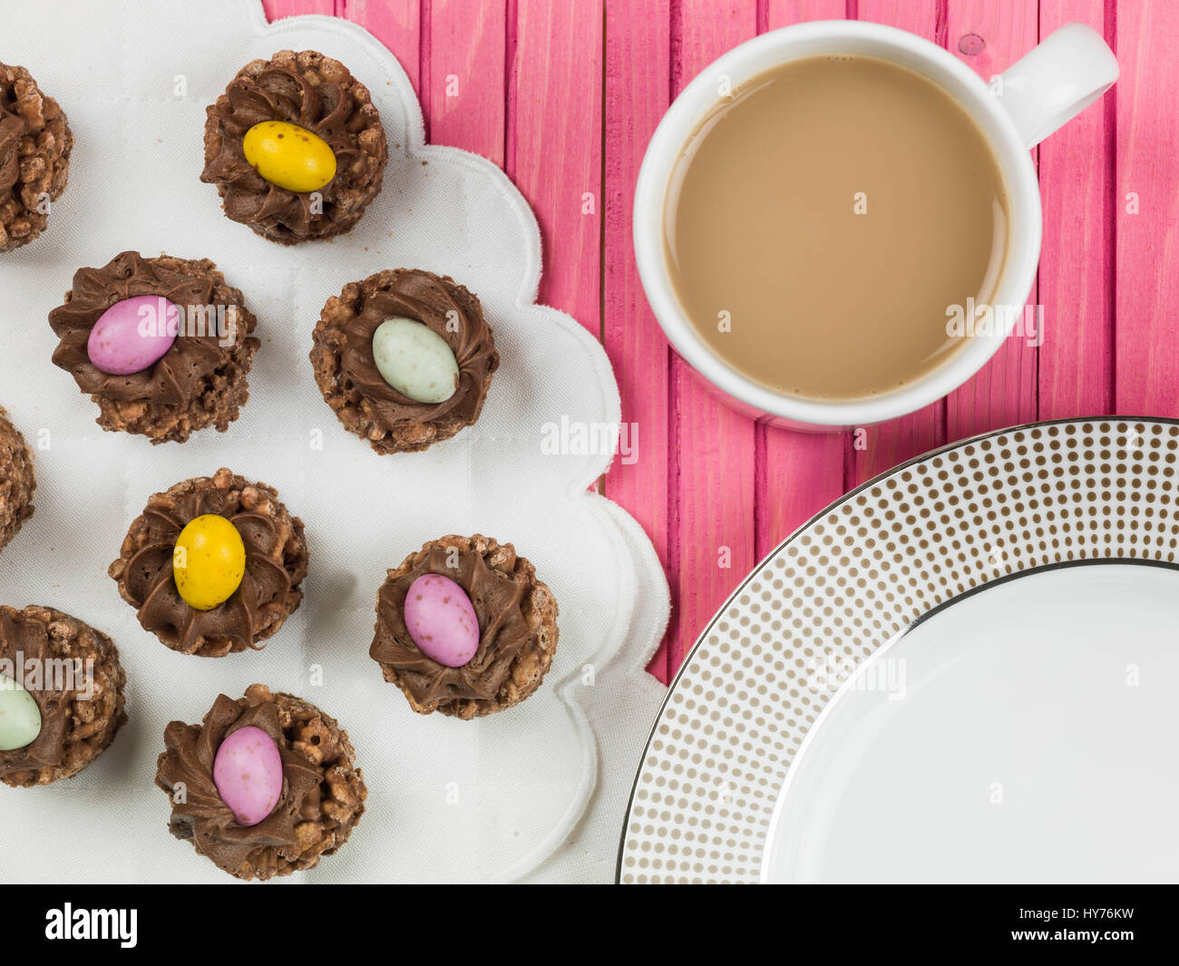 Easter Chocolate Crispy Cereal Nests With Mini Easter Eggs Against a Pink Background Stock Photo