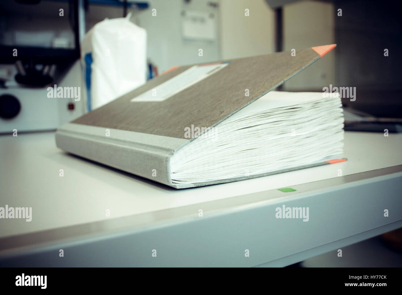 Thick laboratory journal at work, soft focus Stock Photo - Alamy
