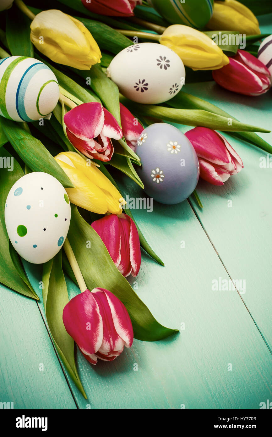 Red and yellow tulips with colorful Easter eggs Stock Photo - Alamy