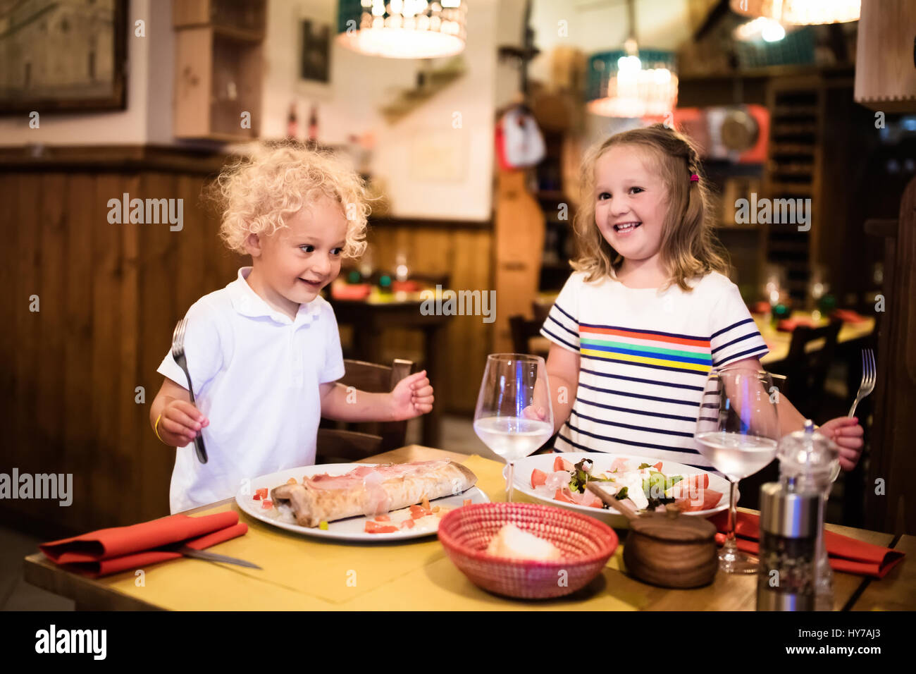 Kids Eat Pizza Pasta And Salad In Traditional Restaurant Eating Stock Photo Alamy