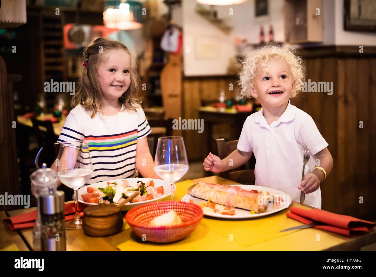 Kids Eat Pizza Pasta And Salad In Traditional Restaurant Eating Stock Photo Alamy