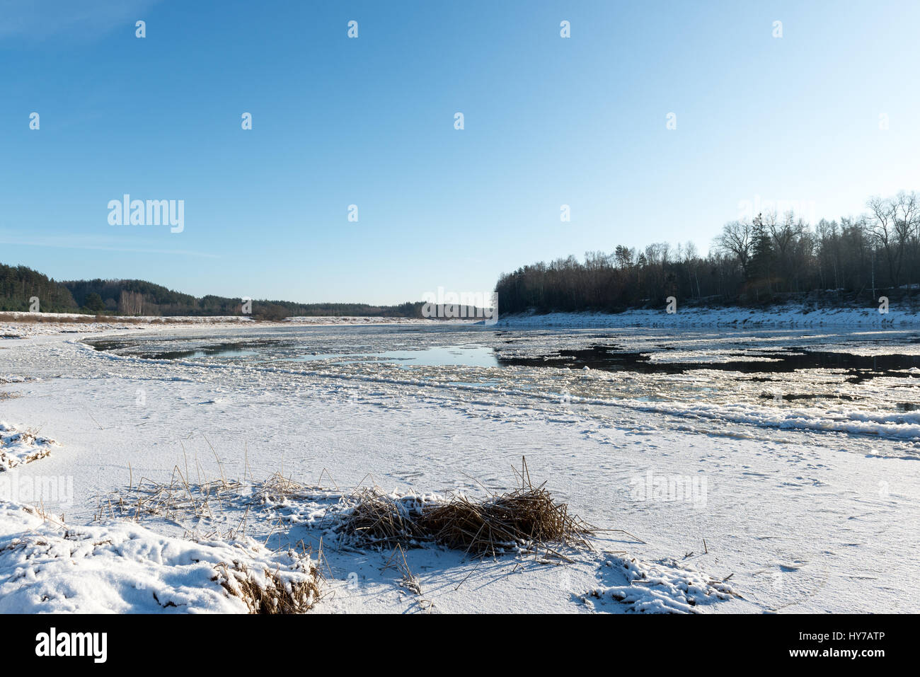 beautiful snowy winter landscape with frozen river and blue sky Stock ...