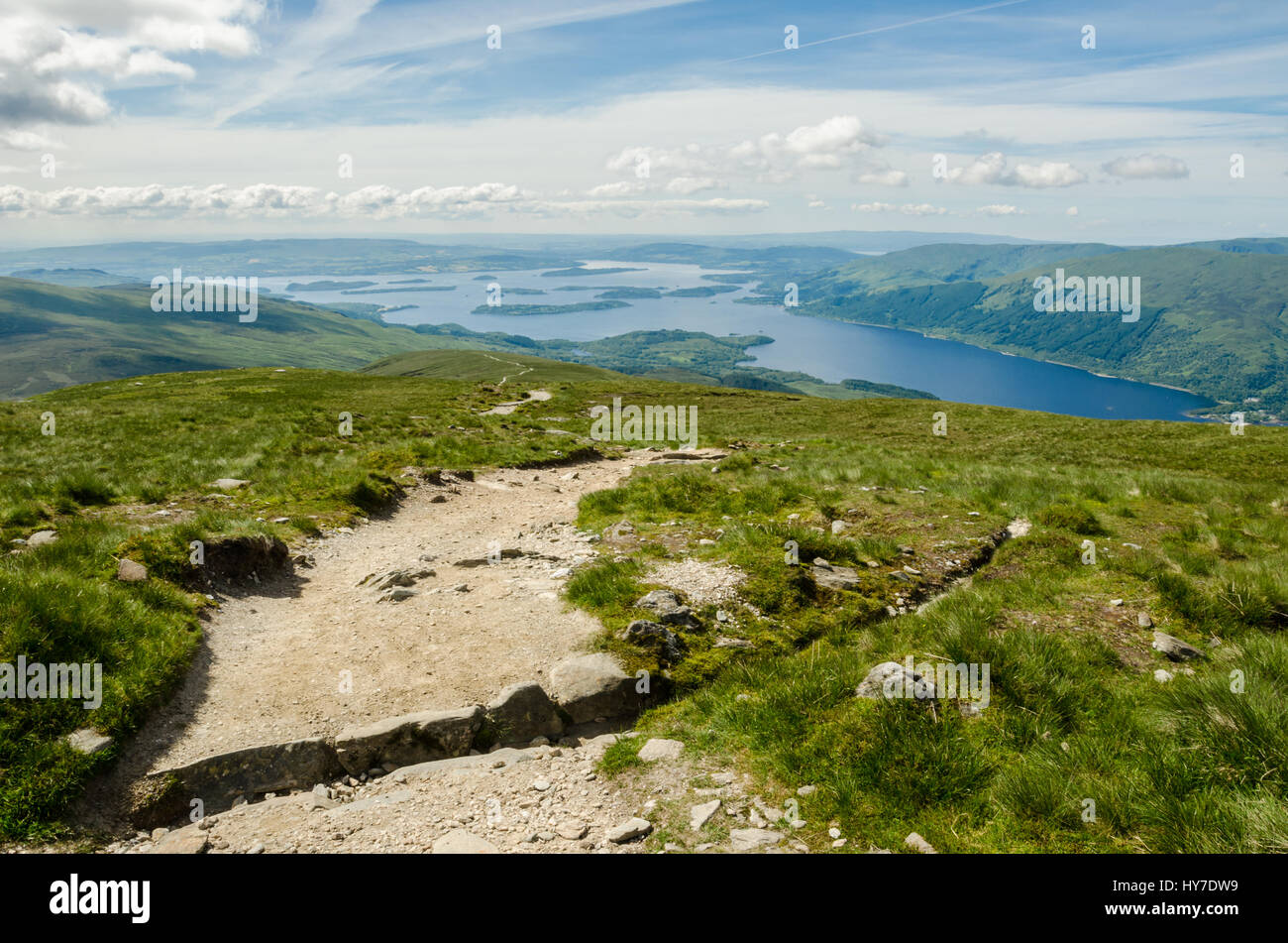 Path leading to the top of Ben Lomond in a sunny day. Loch Lomond in