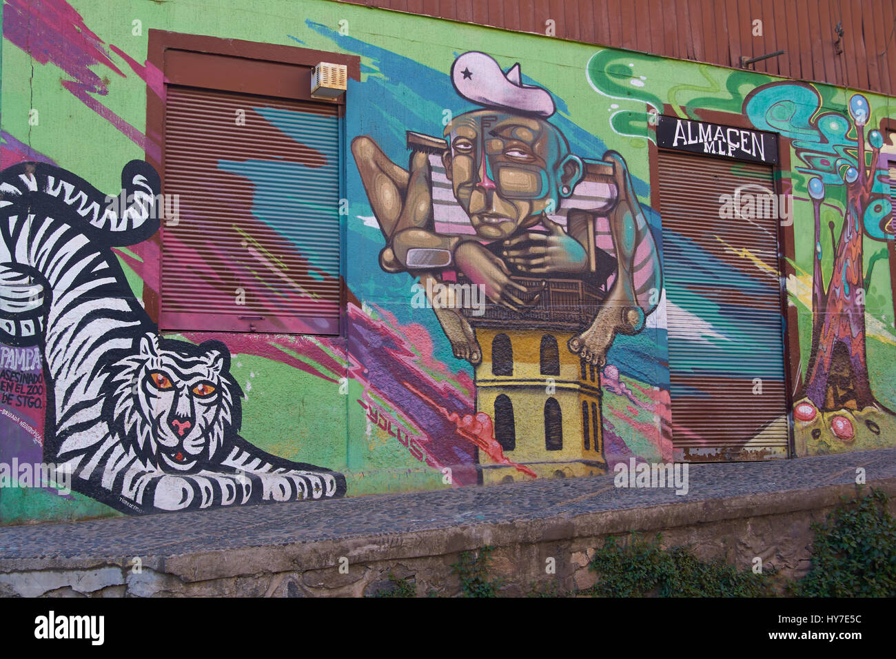Street art decorating buildings in the UNESCO World Heritage area of the port city of Valparaiso in Chile. Stock Photo