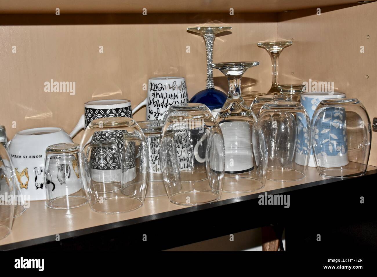 Glasses and coffee mugs on shelf Stock Photo Alamy