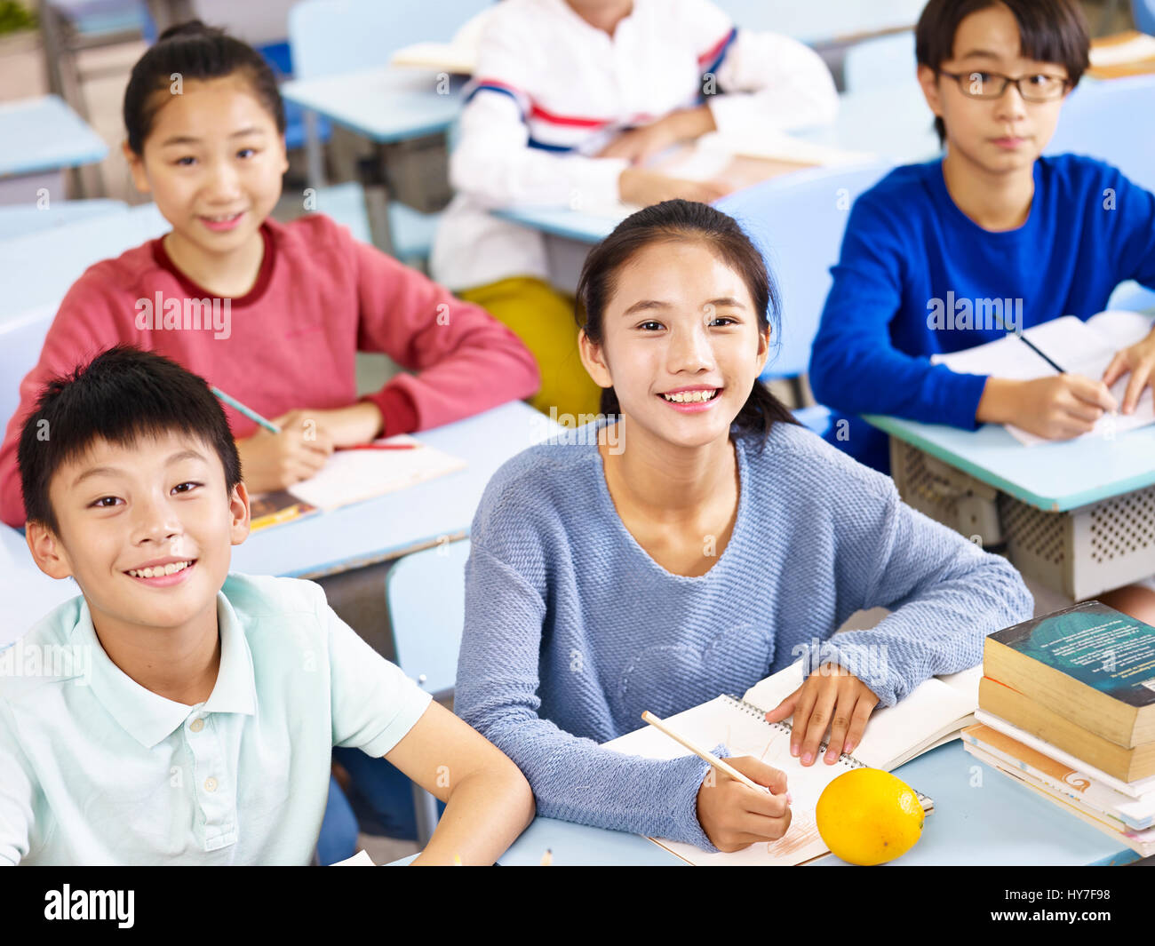 asian grade school students sitting in classroom, high angle view. Stock Photo