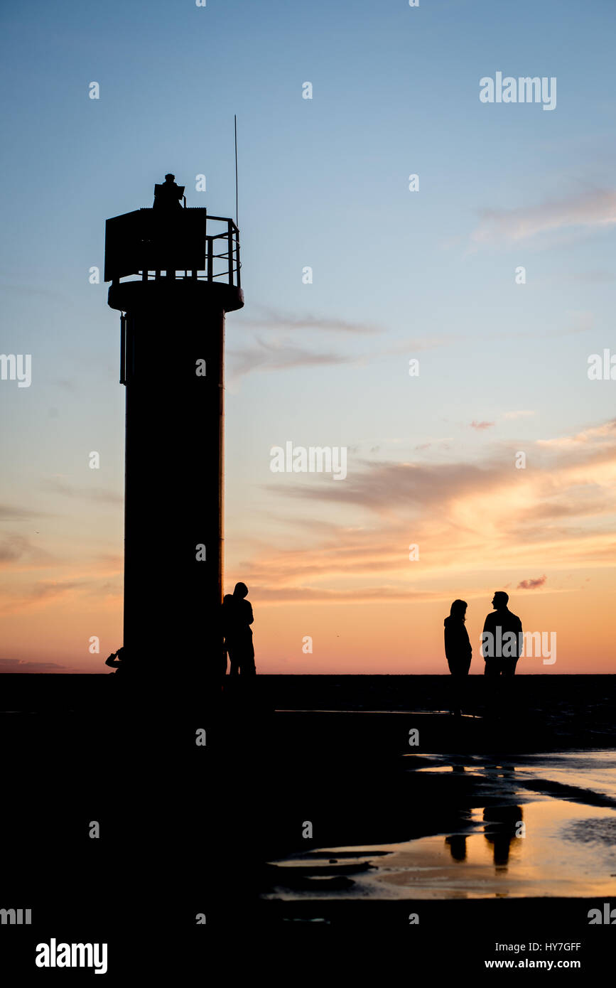 lighthouse with rusty metal rails near sea port and silhouettes Stock ...