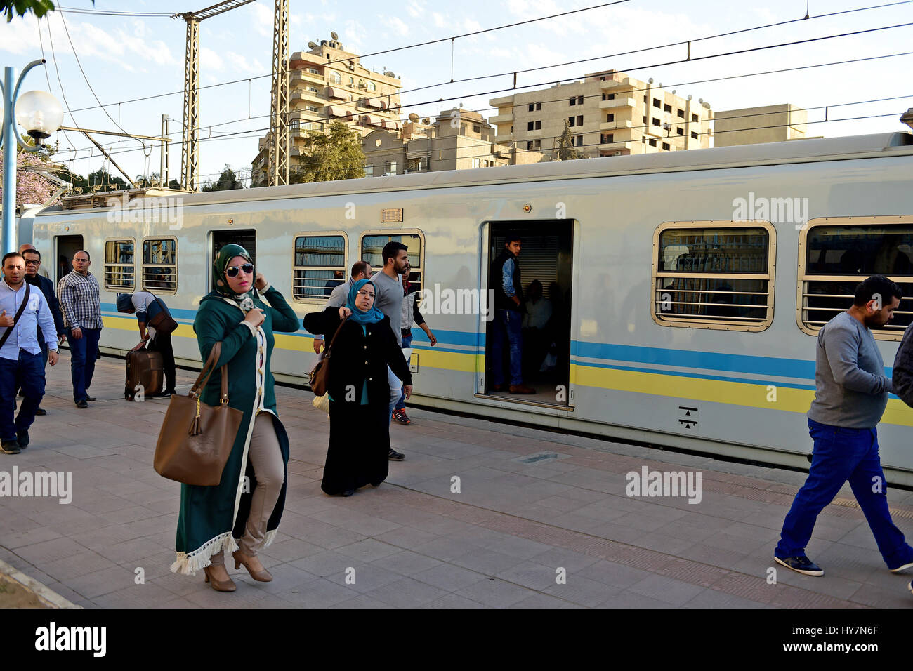 Cairo. 31st Mar, 2017. Passengers walk past a metro train at Maadi metro station in Cairo, Egypt on March 31, 2017. Egypt has doubled Cairo metro fare amid financial difficulties and nearly 3.5 million commuters relying on Cairo's metro everyday fumed by the move, as they already suffered sharp rise in living costs. Credit: Zhao Dingzhe/Xinhua/Alamy Live News Stock Photo
