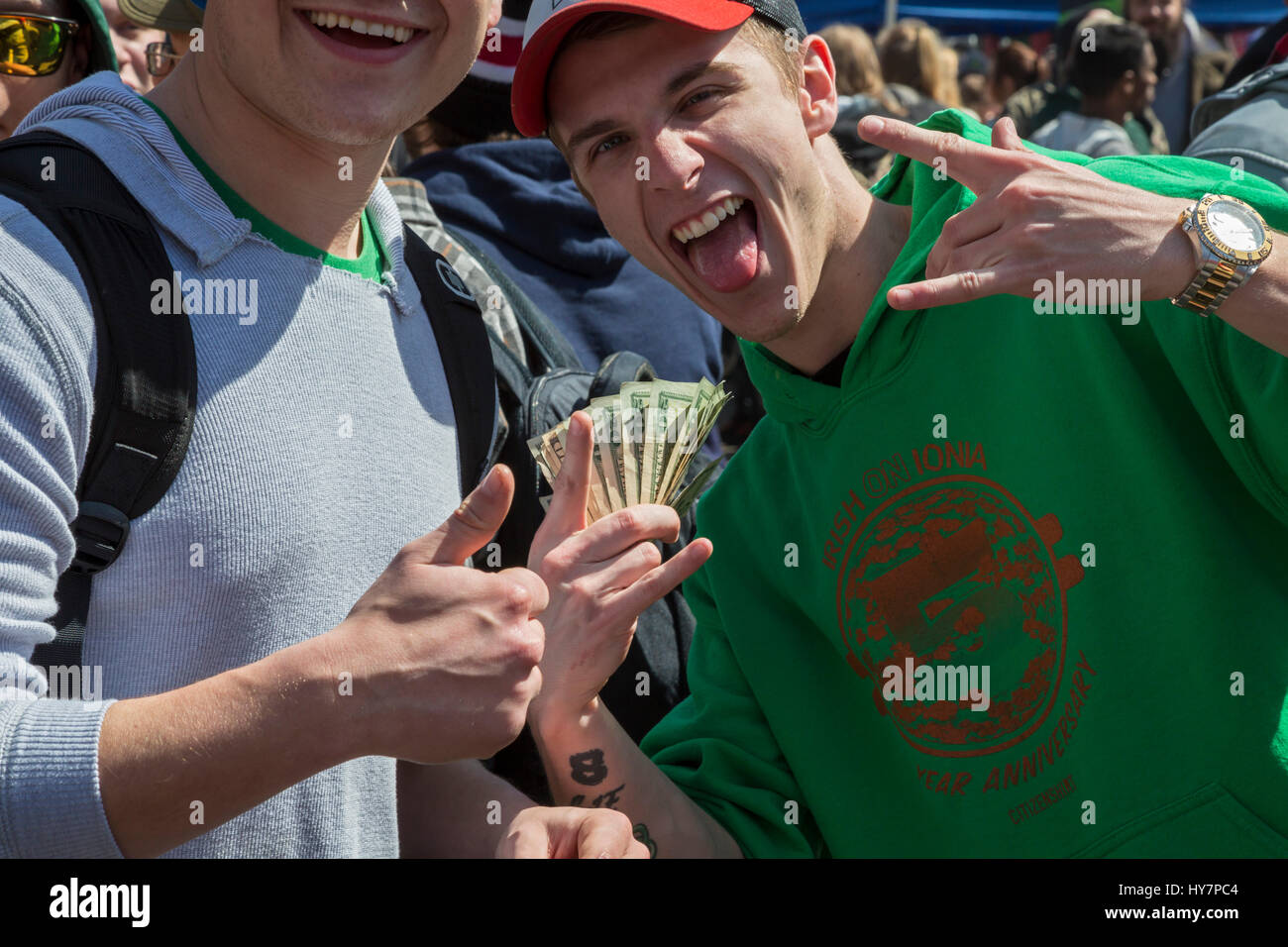 Ann Arbor, Michigan, USA. 1st April 2017. Vendors of marijuana-themed merchandise celebrate during the annual Hash Bash, a 45-year tradition at the University of Michigan. The event is devoted to music and speeches advocating the legalization of marijuana, and for many, the smoking of marijuana. Credit: Jim West/Alamy Live News Stock Photo