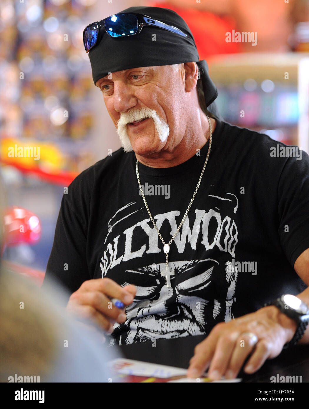 Orlando, Florida, USA. 1st April, 2017. Semi-retired professional wrestler Terry Gene Bollea, better known by his ring name Hulk Hogan, signs autographs for fans at Hogan's Beach Shop, his retail merchandise store  which opened on March 30, 2017 in Orlando, Florida. Credit: Paul Hennessy/Alamy Live News Stock Photo