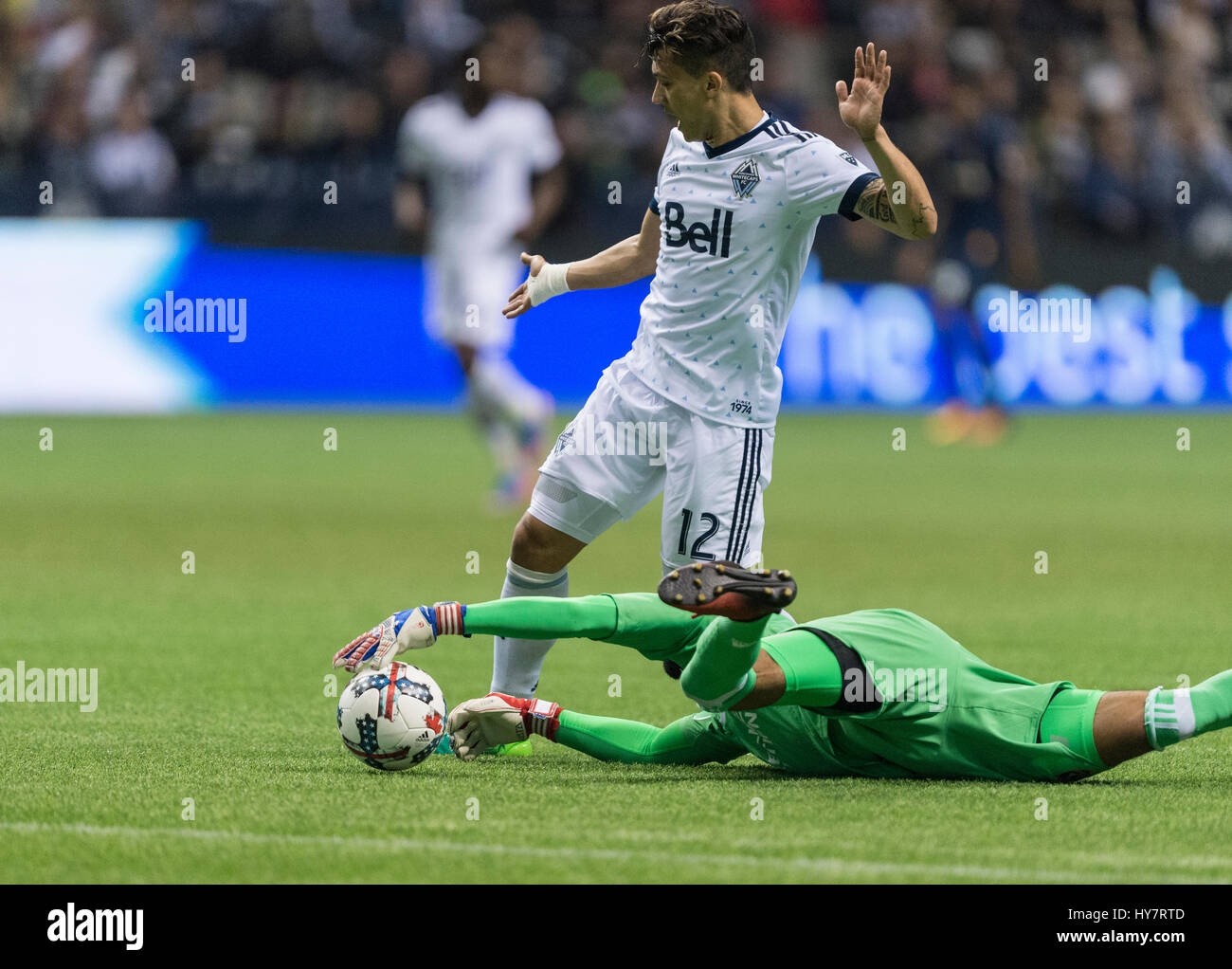 Vancouver, Canada. 1 April, 2017. Goalkeeper Clement Diop (31) of Los Angeles Galaxy, grabbing the ball from Fredy Montero (12) of Vancouver Whitecaps. Vancouver defeats Los Angeles 4-2, with Whitecap goals from Cristian Techera (13), Fredy Montero (12) and 2 goals from Matias Laba (15), Vancouver Whitecaps vs Los Angeles Galaxy, BC Place Stadium. © Gerry Rousseau/Alamy Live News Stock Photo