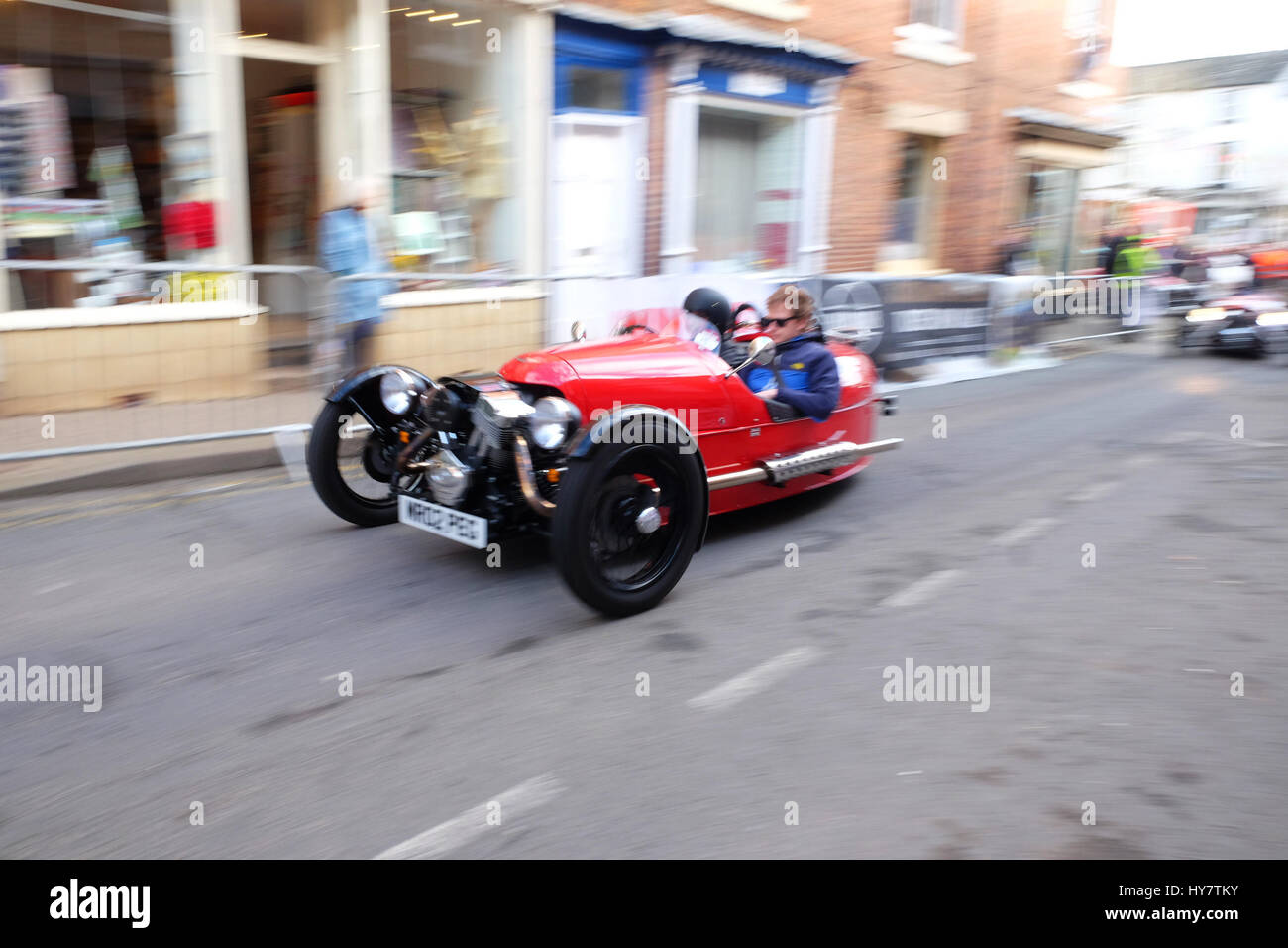 Bromyard Speed Festival, Herefordshire, UK - April 2017 - Vintage cars roar through the town centre of Bromyard as fans watch at Bromyard for the 2nd Speed Festival. The photo shows a three wheel Morgan car. Photo Steven May / Alamy Live News Stock Photo