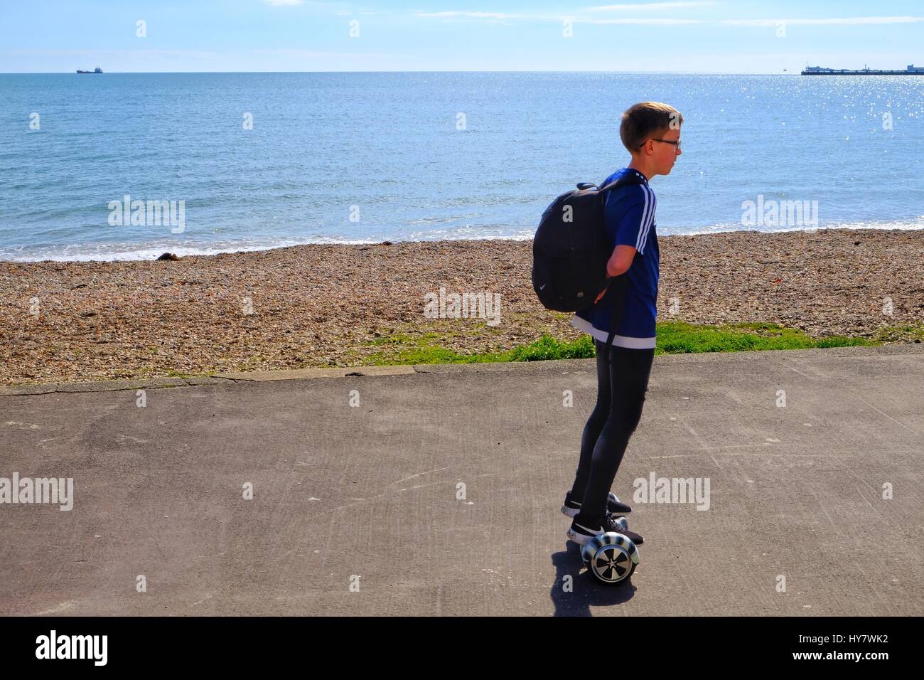 Weymouth, Dorset, UK. 2 April 2017.  A young person enjoys a modern way to prominade along the seafront in Weymouth as the temprature continues to stay above the seasonal average. Credit: Tom Corban/Alamy Live News Stock Photo