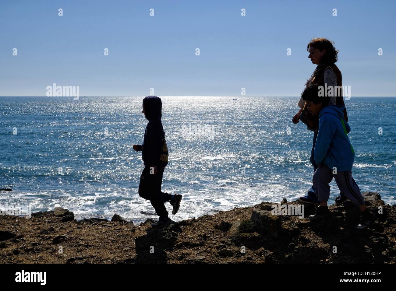 Portland Bill, Dorset, UK. 2nd Apr, 2017. Visitors Silhouetted against the sea as visitors flock to Portland Bill as the good weather continues in the South West Credit: Tom Corban/Alamy Live News Stock Photo