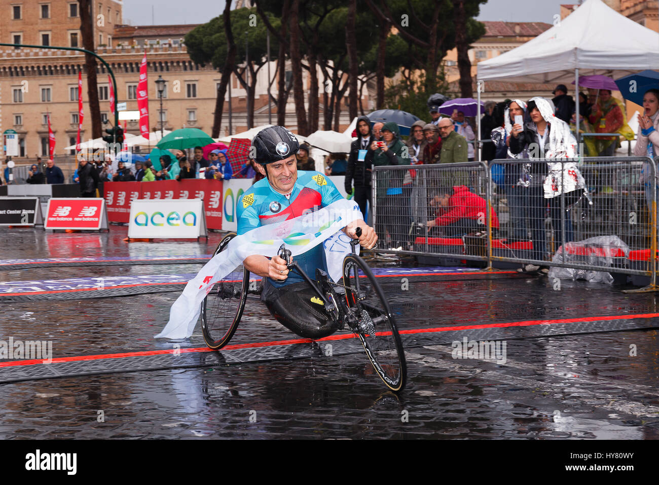 Rome, Italy. 02nd Apr, 2017. Alex Zanardi is the winner of the hand bike race of 23rd Rome Marathon. Zanardi arrival at the finish line in the rain. Credit: Polifoto/Alamy Live News Stock Photo