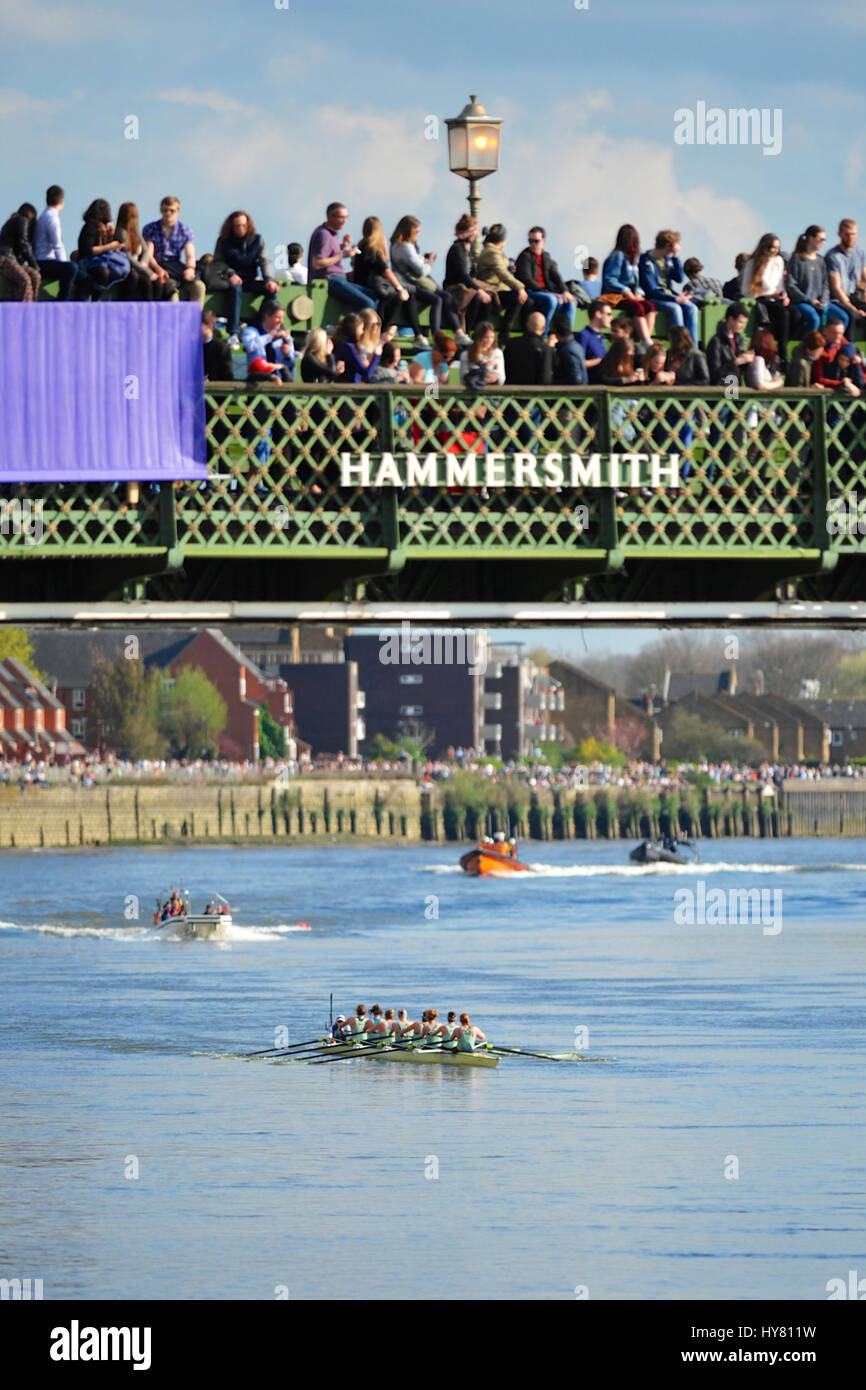 London, UK. 02nd Apr, 2017. Cambridge rowing hard and leading the way as the University Boat race passes underneath Hammersmith Bridge.   The Boat Race is an annual contest between two rowing crews from Oxford and Cambridge universities.  on the River Thames in West London between Putney and Mortlake. First raced in 1927, The Cancer Research UK Boat Race is amongst the oldest sporting events in the world.   The first boat race for men took place in 1829 in Henley on Thames following a challenge between old school friends. Credit: Michael Preston/Alamy Live News Stock Photo