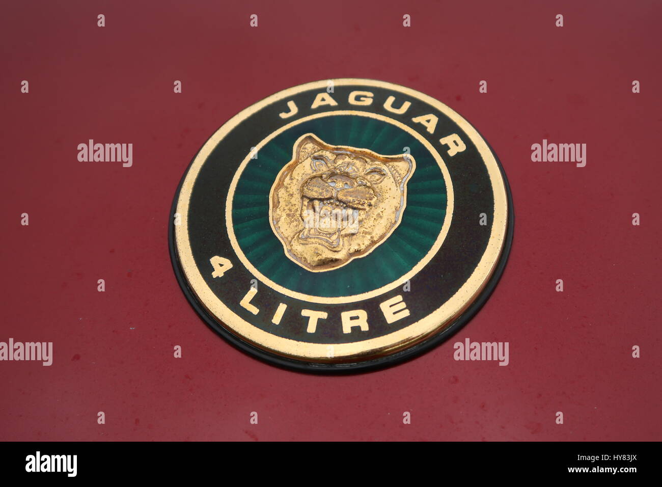 Jaguar 4 Litre Badge on Maroon car Stock Photo