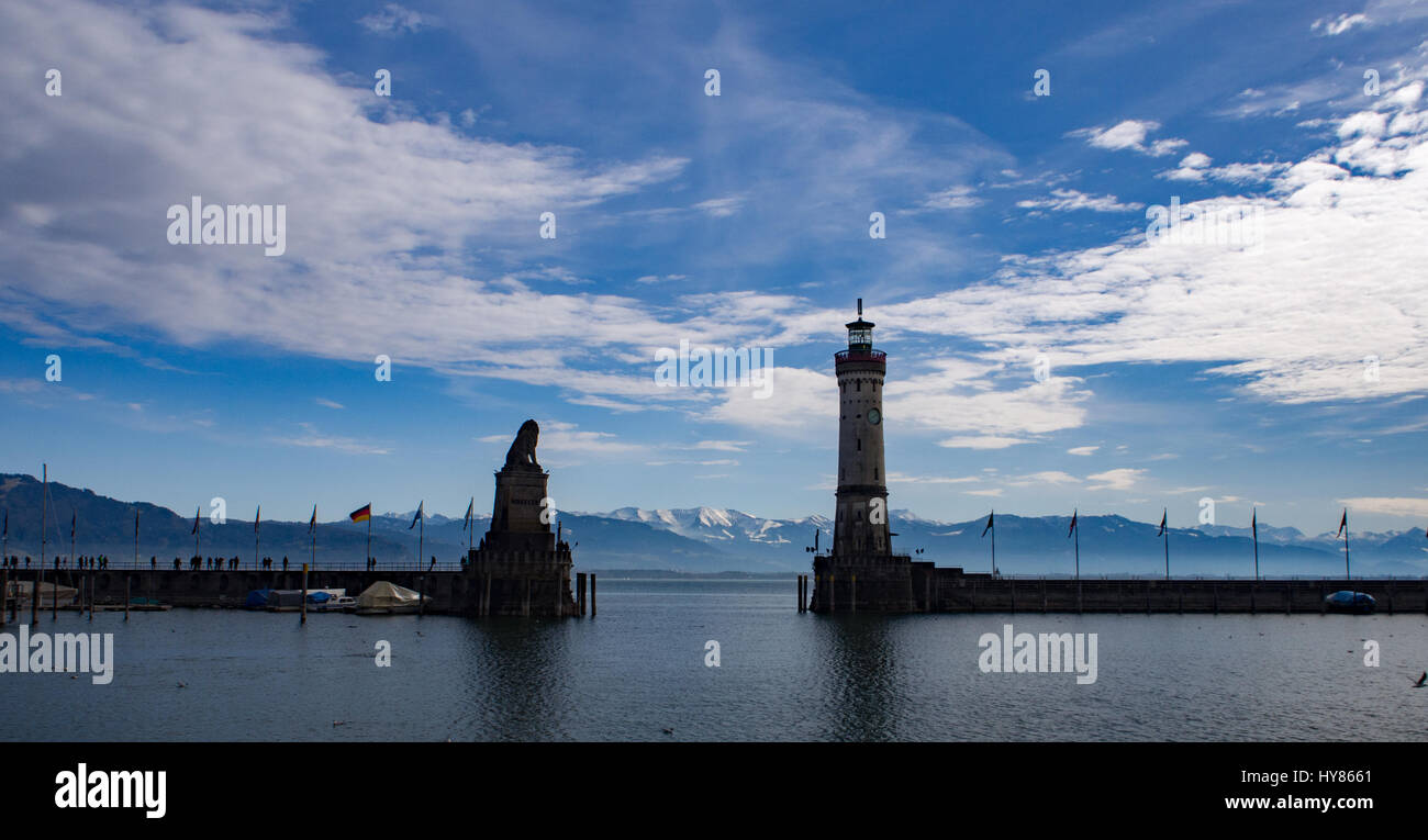 A view of he Swiss Alps through Lindau Harbour mouth, Lindau Germany Stock Photo