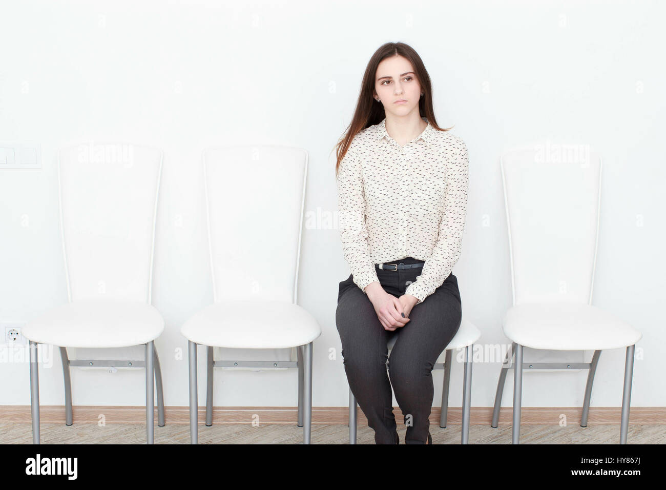 Young woman in waiting room being bored Stock Photo Alamy