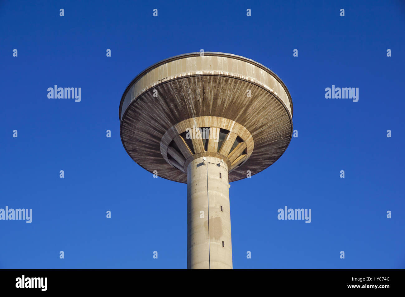 concrete water tower against blue sky Stock Photo