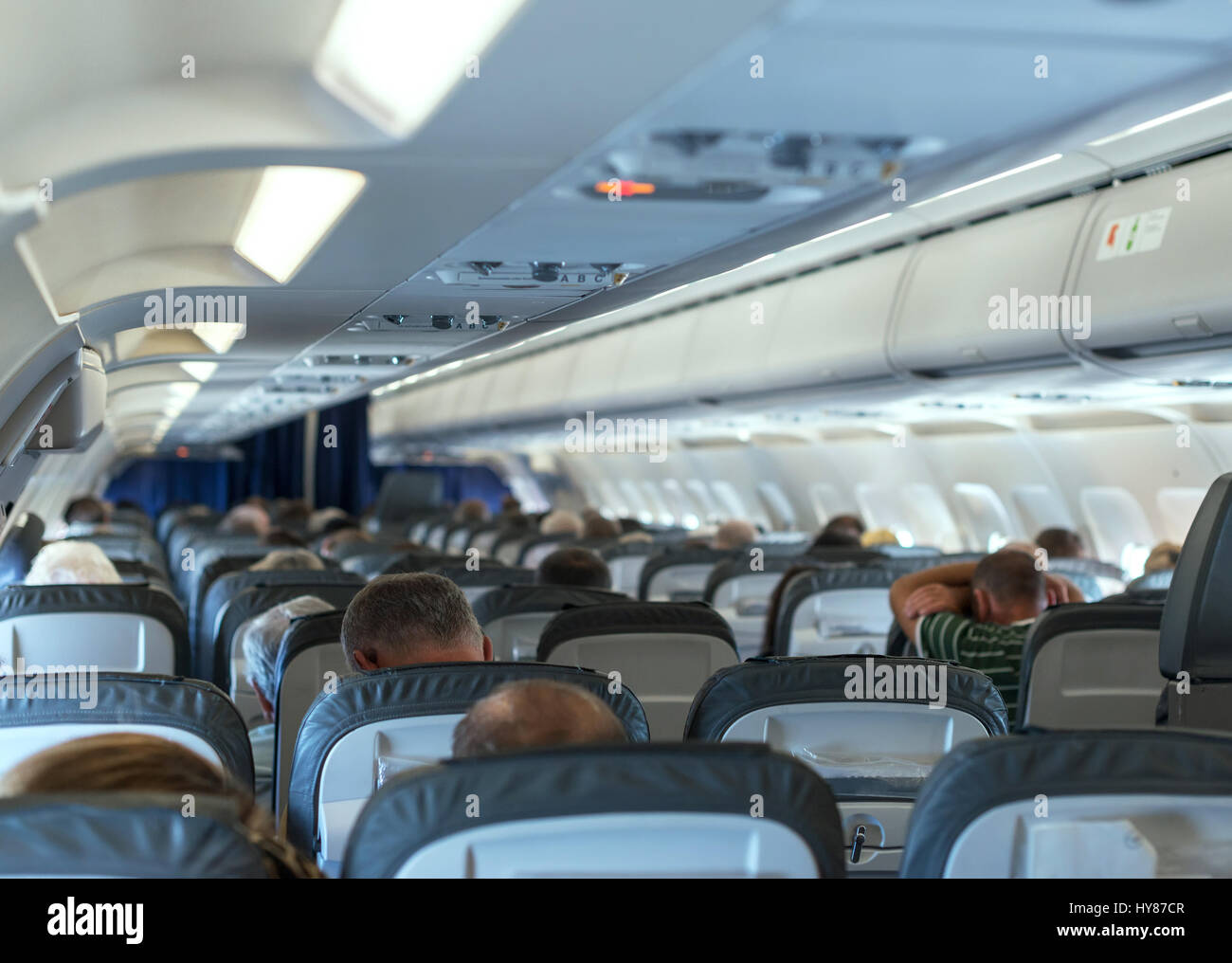 Interior inside of the plane with passengers. Stock Photo