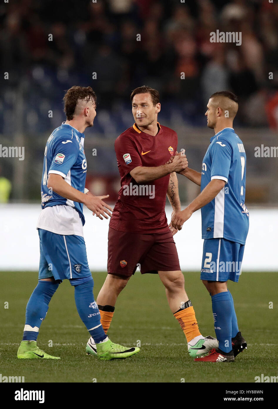 Rome, Italy. 01st Apr, 2017. Roma Francesco Totti, center, greets Empoli Marcel Buchel, left, and Vincent Laurini during the Serie A soccer match between Roma and Empoli at the Olympic stadium. Roma won 2-0. Credit: Isabella Bonotto/Pacific Press/Alamy Live News Stock Photo