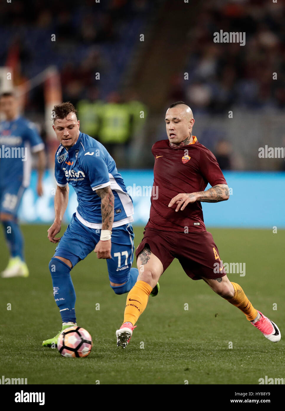 Rome, Italy. 01st Apr, 2017. RomaÕs Radja Nainggolan, right, is challenged by Empoli Marcel Buchel during the Serie A soccer match between Roma and Empoli at the Olympic stadium. Roma won 2-0. Credit: Isabella Bonotto/Pacific Press/Alamy Live News Stock Photo