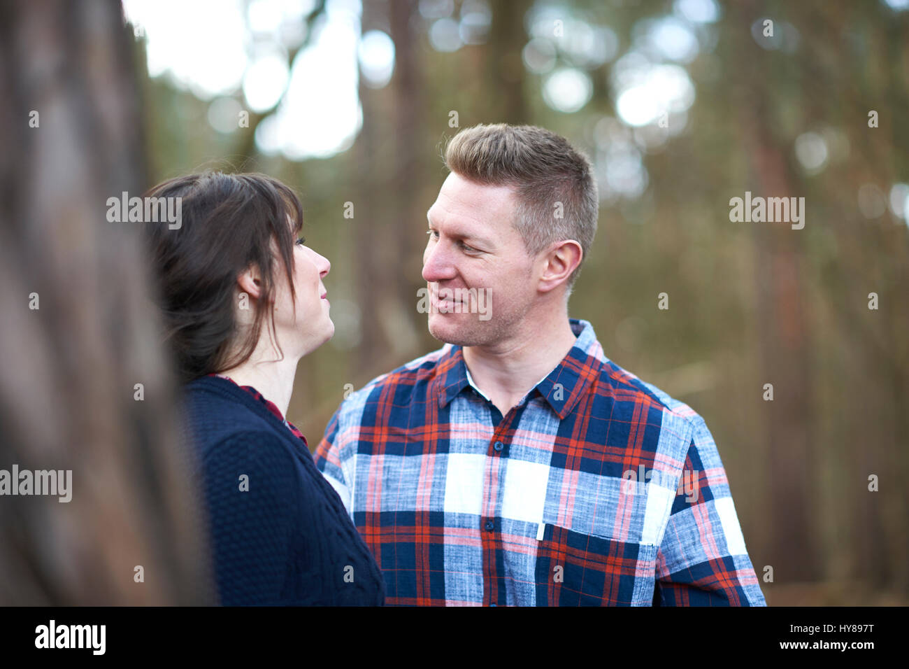A young couple on a walk in the woods Stock Photo