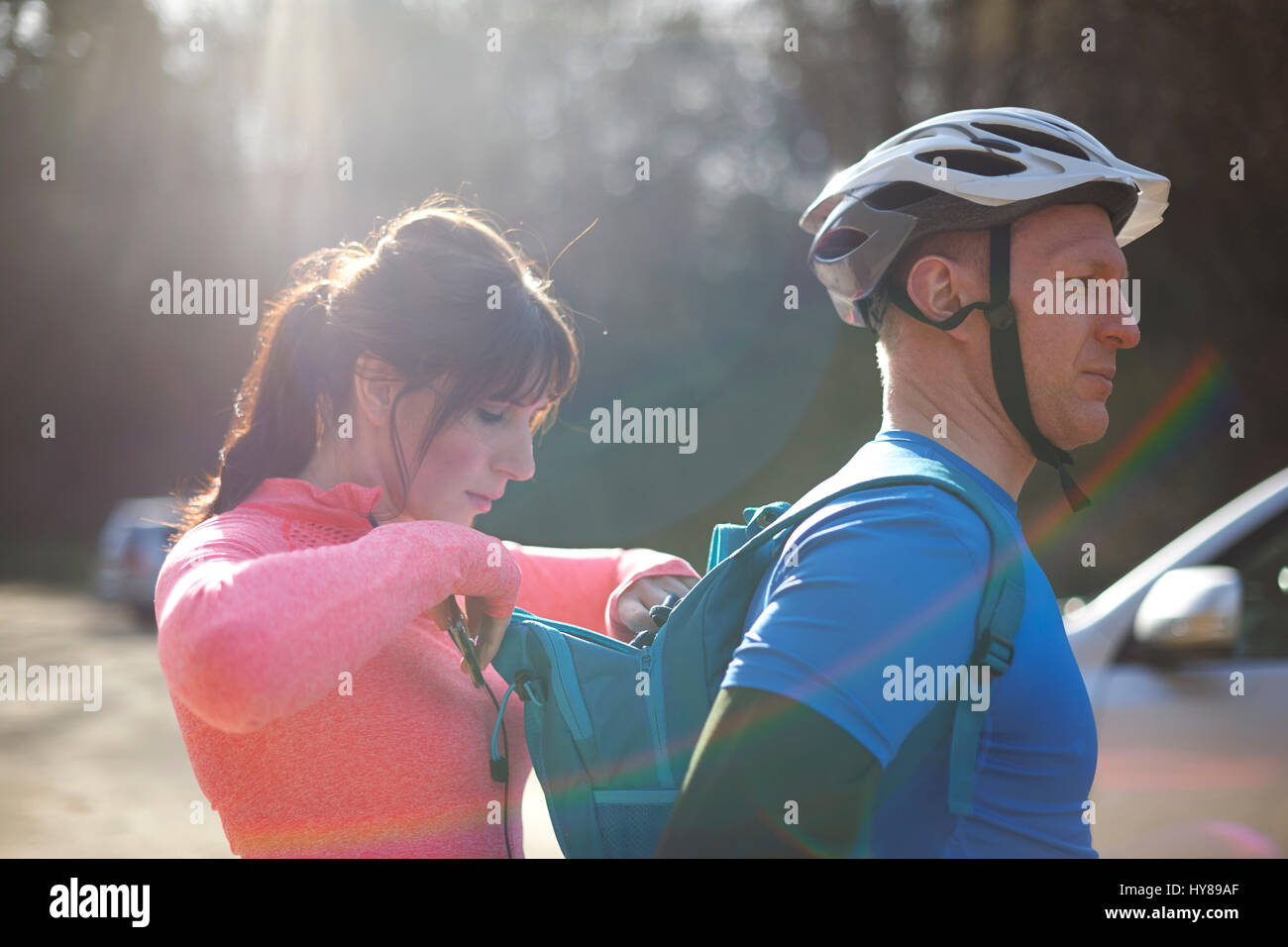 A young couple prepare to exercise in the woods Stock Photo