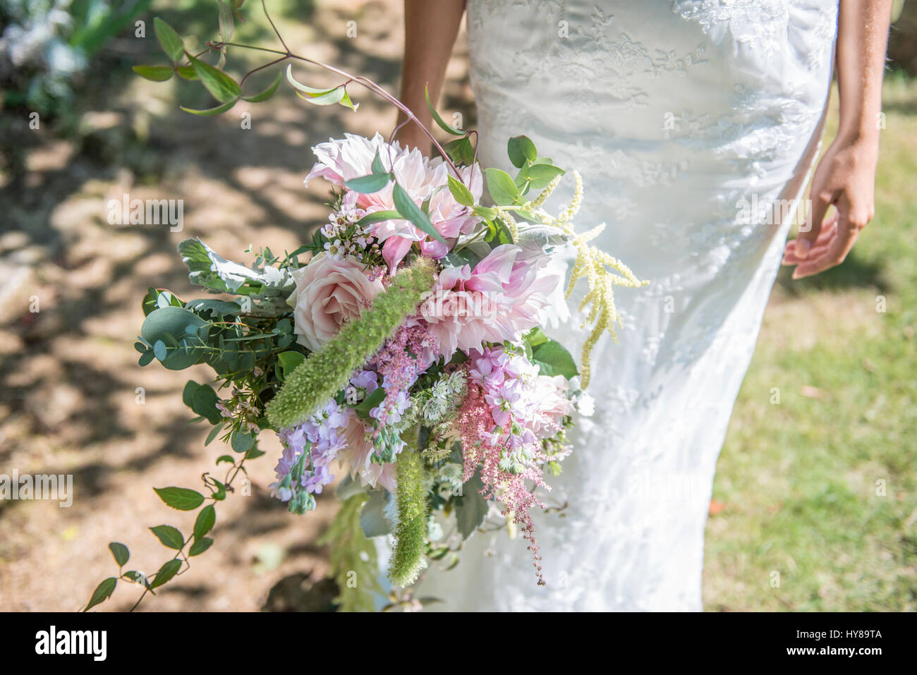 A bride holding a bouquet of flowers on her wedding day Stock Photo