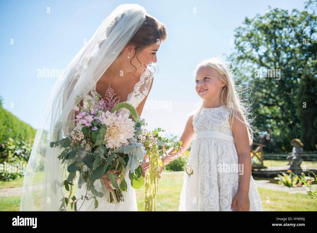A bride with her young bridesmaid on her wedding day Stock Photo